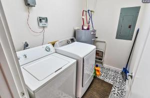a small laundry room with a washer and dryer at Lakefront Home on Water with Great Views, Boat Dock, Al Fresco Dining, and WiFi in Kingsland +28 photos