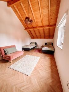 a attic room with two beds and a couch at PiuPiuStays in Vermelho +18 photos