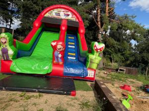 a inflatable bounce house in a yard at Domek letniskowy Jemiołowo in Olsztynek