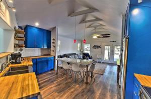 a kitchen with blue cabinets and a table with chairs at Lakefront Home on Water with Great Views, Boat Dock, Al Fresco Dining, and WiFi in Kingsland