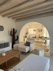 a living room with a couch and a table at Topos exclusive Mykonos in Agios Ioannis Mykonos