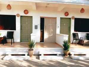 a room with three doors and two chairs and benches at Sea Apartments in Larnaca