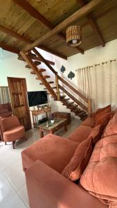 a living room with a couch and a table at Vila Uryah in Caraíva