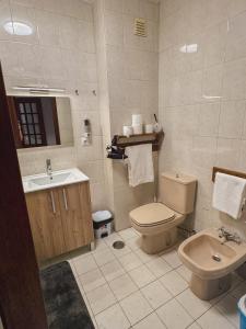 a bathroom with a toilet and a sink at Titi's House in Gulpilhares +7 photos