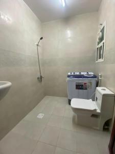 a bathroom with a toilet and a sink at الفردوس - RED14 Al-Firdous in Salalah