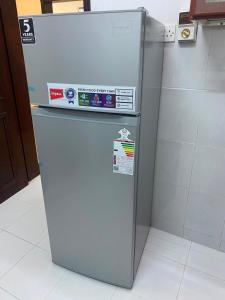 a white refrigerator sitting in a kitchen at الفردوس - RED14 Al-Firdous in Salalah