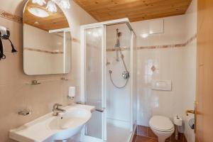 a bathroom with a shower and a sink and a toilet at Unterbergerhof - Escape daily life - Enjoy nature - Explore more with activeCARD Sterzing in Val di Vizze