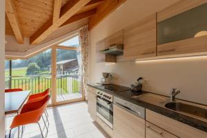 a kitchen with a sink and a counter with a window at Unterbergerhof - Escape daily life - Enjoy nature - Explore more with activeCARD Sterzing in Val di Vizze +64 photos