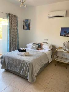 a bedroom with a bed with two stuffed animals on it at ATLANTIS Penthouse Apartment with Jacuzzi plus Pool and Sea Views in Peyia +33 photos