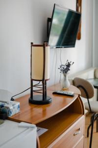 a desk with a television and a remote control on it at Casa Ienciu in Sibiu +19 photos