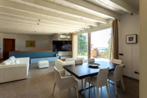a living room with a table and a couch at Sunset Serenity Villa in Padenghe sul Garda