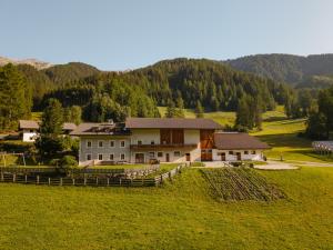 a house in the middle of a grassy field at Unterbergerhof - Escape daily life - Enjoy nature - Explore more with activeCARD Sterzing in Val di Vizze