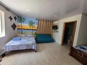 a bedroom with a bed and a view of the ocean at Bella Marcela in Buenavista
