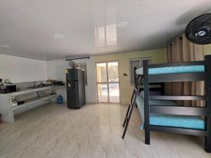a room with a bunk bed and a refrigerator at Bella Marcela in Buenavista