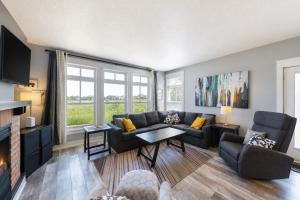 a living room with a couch and a table at Rivergrass by Property Valet in Blue Mountains