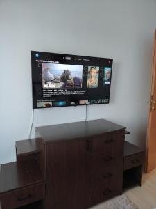 a flat screen tv hanging on a wall at Adrian Home City in Ploieşti