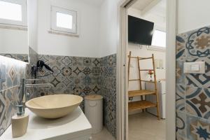 a bathroom with a bowl sink on a counter at Villa Nicole Vista Mare in Andrano