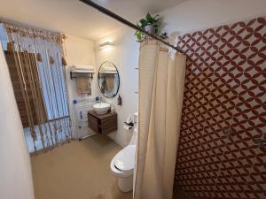 a bathroom with a toilet and a sink at Seres Sayulita Beach Hotel in Sayulita