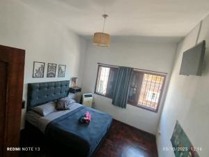 a bedroom with a bed with a pink toy on it at Güemes Hostel Cordoba in Córdoba