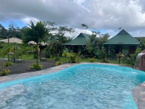 a swimming pool in front of a house at Chongos Place in Fortuna
