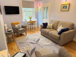 a living room with a couch and a table at Largo Bay - Harbour Hideaway in Leven