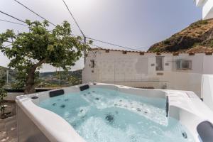 a jacuzzi tub in the backyard of a house at Villa Amada in Vega de San Mateo