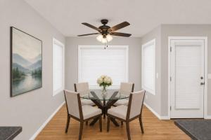 a dining room with a table with chairs and a ceiling fan at PINE AND TIMBER GETAWAY in Jackson