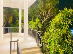a porch of a house with a view of trees at The Royal Ember in Arugam Bay
