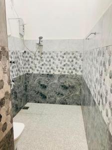 a bathroom with a shower and a toilet at The Royal Ember in Arugam Bay