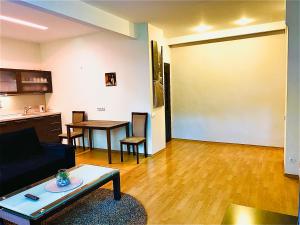 a living room with a couch and a table at Klaipeda City Center Aparment in Klaipėda