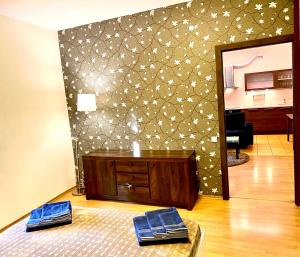 a living room with a table and a wall at Klaipeda City Center Aparment in Klaipėda