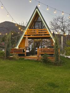 a house with a bench and lights in the yard at Villa Venus in Ferizaj