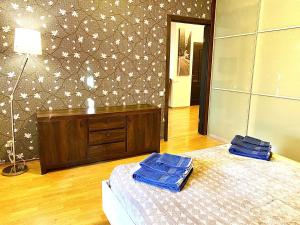 a bedroom with a bed with two blue towels on it at Klaipeda City Center Aparment in Klaipėda +10 photos