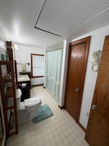 a bathroom with a toilet and a sink at Floral Canal-Facing Hideaway in Chesapeake City +6 photos