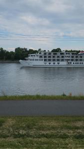 a large white cruise ship on the water at Floral Canal-Facing Hideaway in Chesapeake City