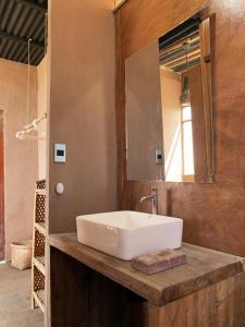 a bathroom with a white sink and a mirror at Los Asentamientos in Máncora