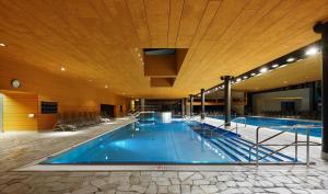 a large swimming pool in a large building at Historic Residence Barbara in Colle Isarco
