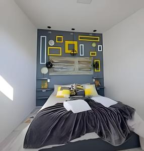 a bedroom with a large bed with yellow accents at 1 Comfortable loft with WiFi and central heating in Coihaique