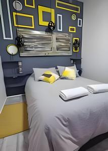 a bedroom with a large bed with yellow and white pillows at 1 Comfortable loft with WiFi and central heating in Coihaique +13 photos