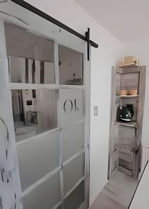 a white room with a cross on the wall at 1 Comfortable loft with WiFi and central heating in Coihaique