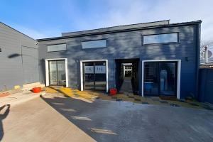 a building with the doors open in a parking lot at 1 Comfortable loft with WiFi and central heating in Coihaique