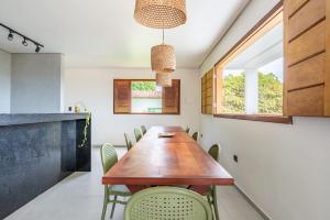 a dining room with a wooden table and chairs at River & Ocean View House with Pool in Igarassu +66 photos