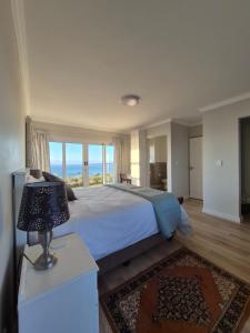 a bedroom with a bed with a view of the ocean at Guests at 32 Nautilus Bay in Dana Bay