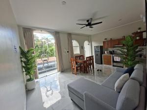 a living room with a couch and a kitchen at Sol de sauce - Casa Vacation Stay in Sauce