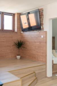 a living room with a flat screen tv on a wall at La casa de papel Apartment in Bjelovar