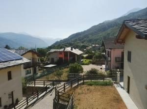 a view of a small town with houses and mountains at Abri Douillet in Saint Marcel