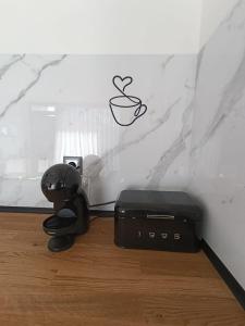 a coffee machine with a cup on the wall at Refúgio D'Aguiar in Aguiar da Beira