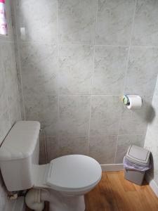 a bathroom with a toilet and a roll of toilet paper at Grand Chalet 64 Disabled Friendly in Skegness +12 photos
