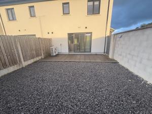 a driveway in front of a house with a fence at No2 WestPoint Donegal Town in Donegal