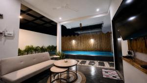 a living room with a couch and a table at Altura Esthetic Villas in Bokor